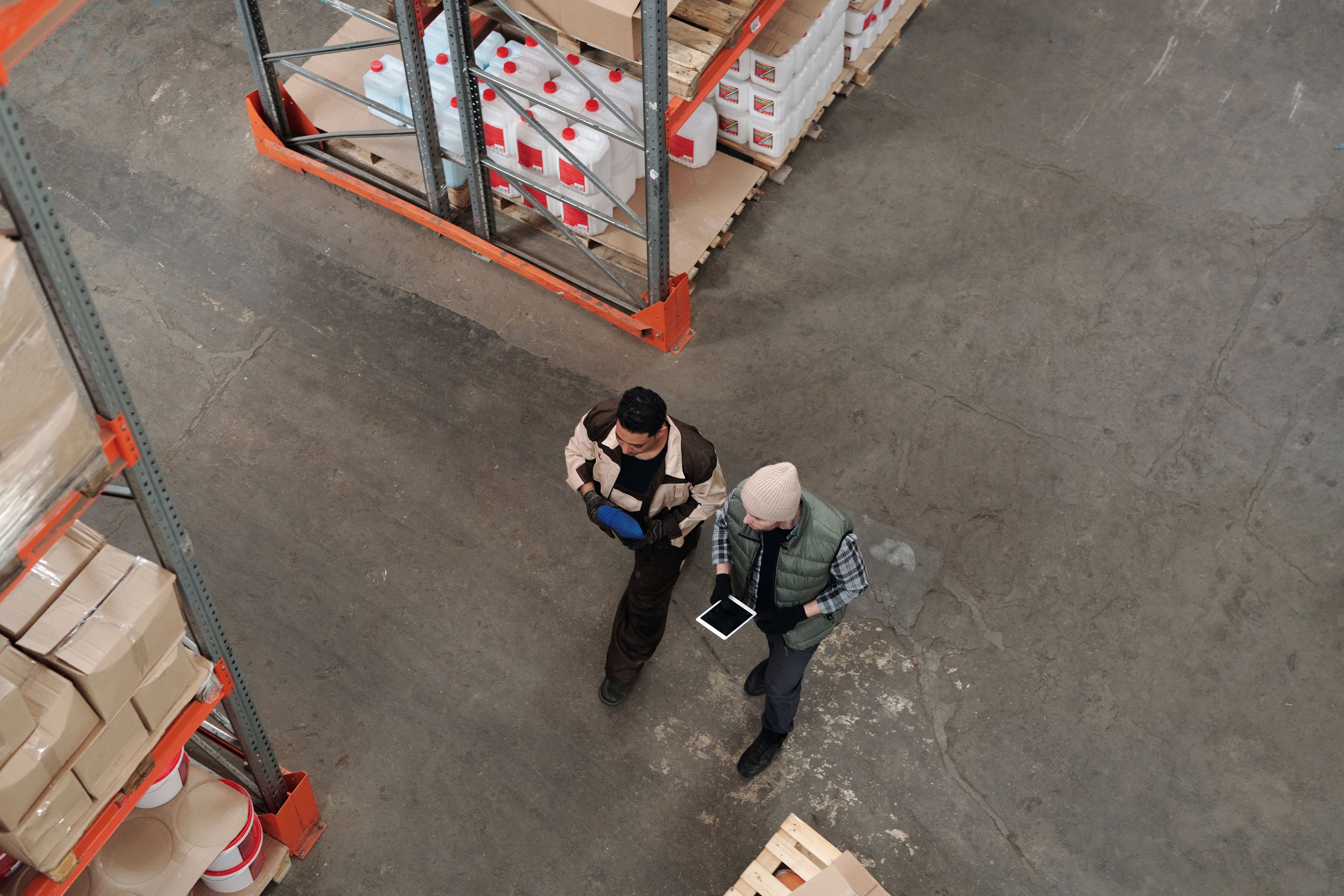 Two warehouse colleagues discussing their work with a tablet.